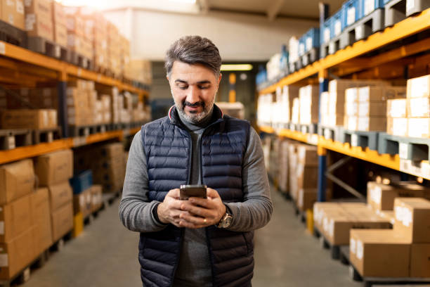 Adult man working in factory warehouse.